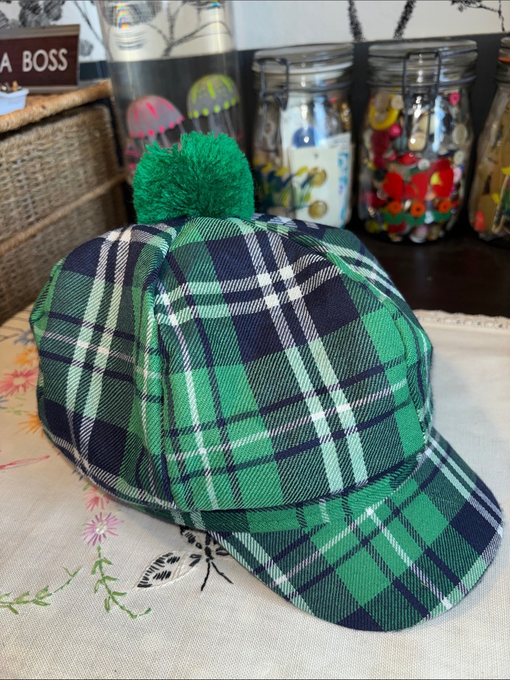 EUC green tartan newsboy-style costume hat adorned with a matching green pom-pom